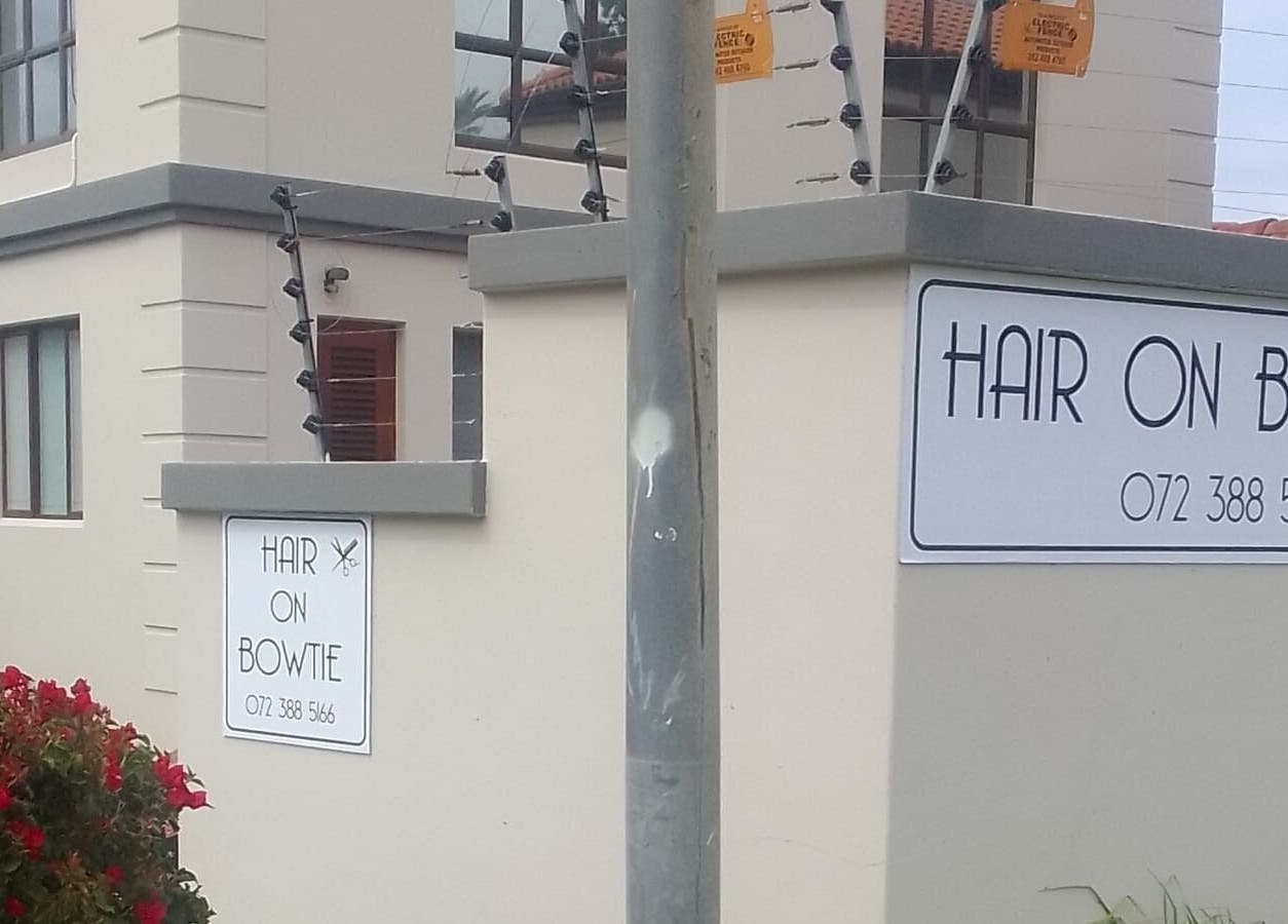 Entrance sign of Hair on Bowtie salon in Plettenberg Bay, Western Cape, ZA offering premium beauty services.
