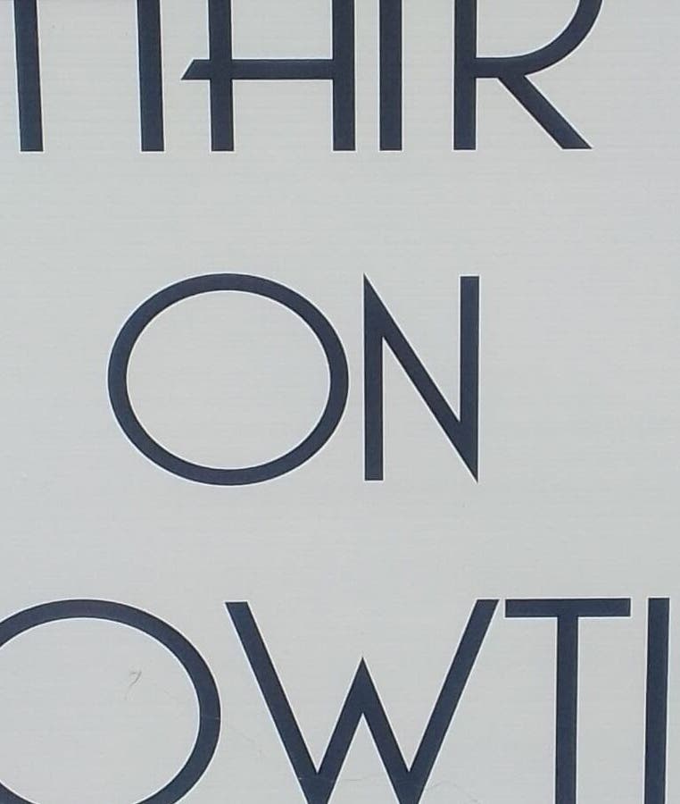 Sign for Hair on Bowtie, Plettenberg Bay, Western Cape, ZA, featuring stylish text and scissors icon.