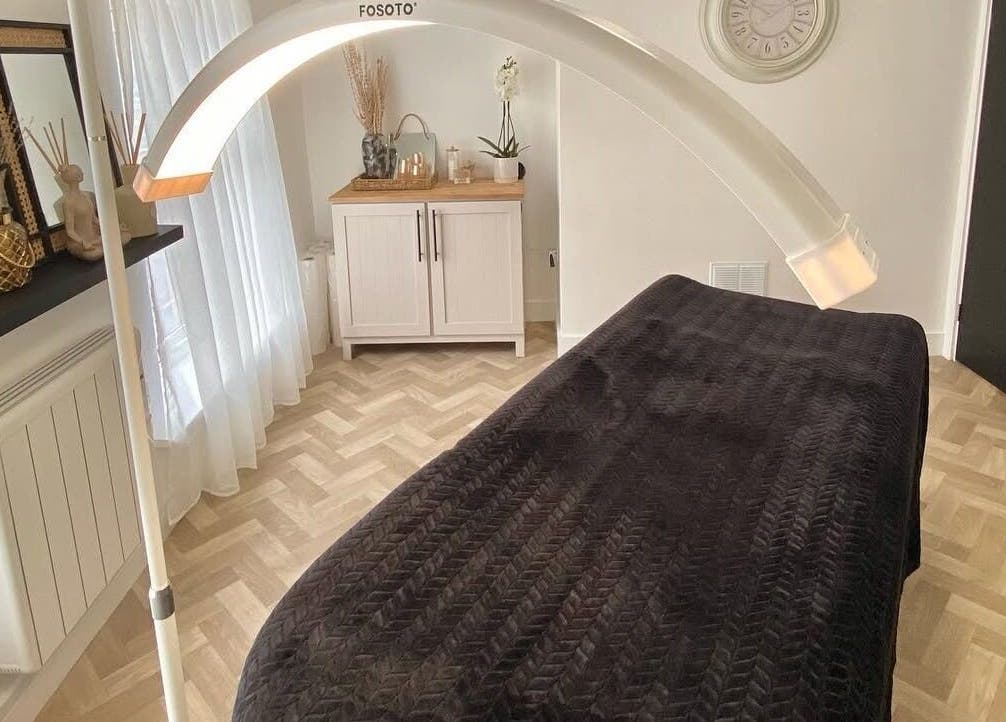 Relaxing spa room at SW Beauty, Stoke-on-Trent, England, GB, featuring a treatment bed under warm ambient lighting.