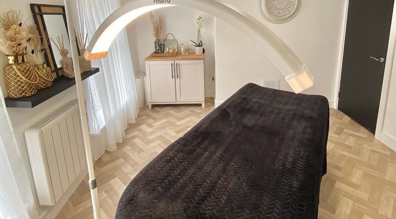 Relaxing spa room at SW Beauty, Stoke-on-Trent, England, GB, featuring a treatment bed under warm ambient lighting.