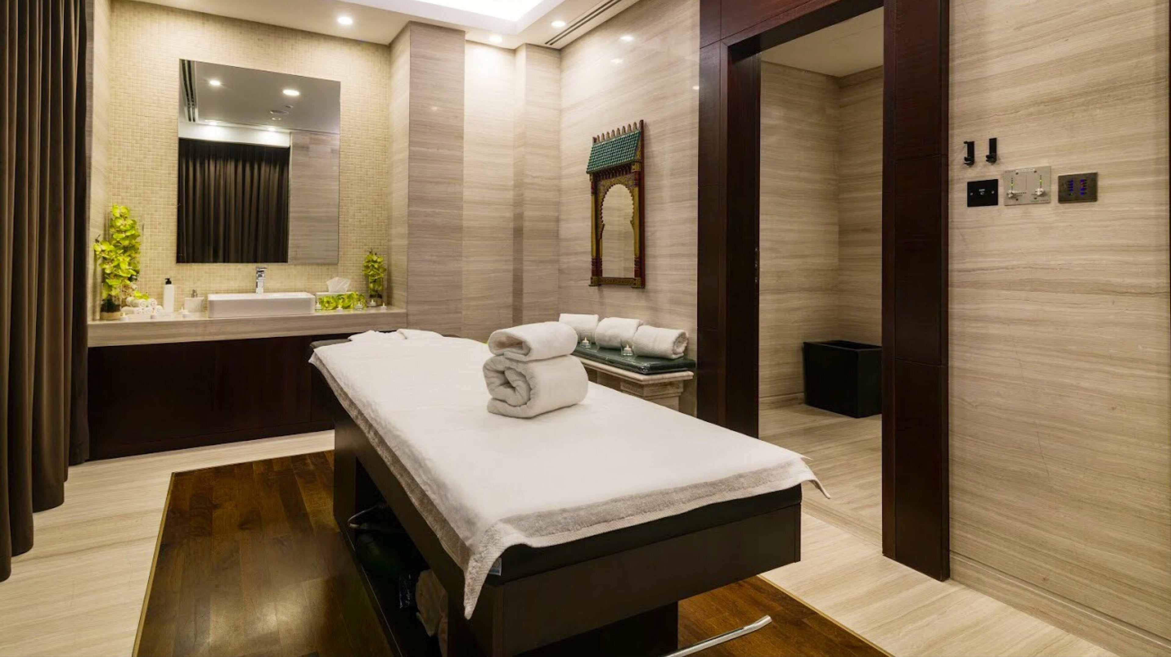 Luxurious spa room at Armonia Spa - Carlton Downtown Hotel, Dubai, AE with massage table and tranquil decor.
