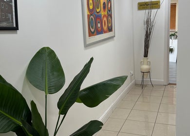 Elegant hallway at Extraordinary Beauty Skills by Aleksandra Yaneva in Northwood, England, GB featuring indoor plant.