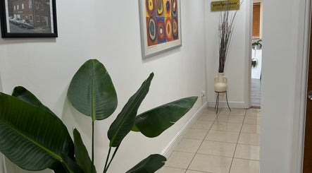 Elegant hallway at Extraordinary Beauty Skills by Aleksandra Yaneva in Northwood, England, GB featuring indoor plant.