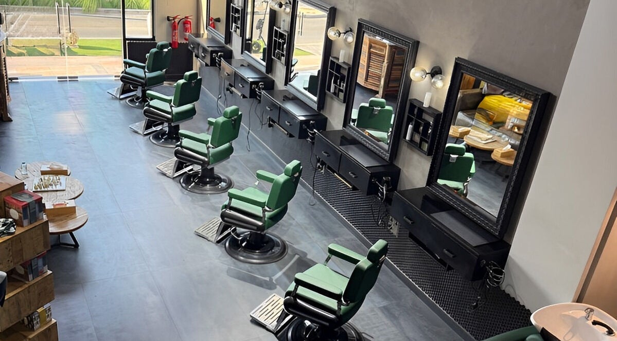 Modern salon interior at Project Hairway - Jumeirah, Dubai, Dubai, AE with stylish green chairs and mirrors.