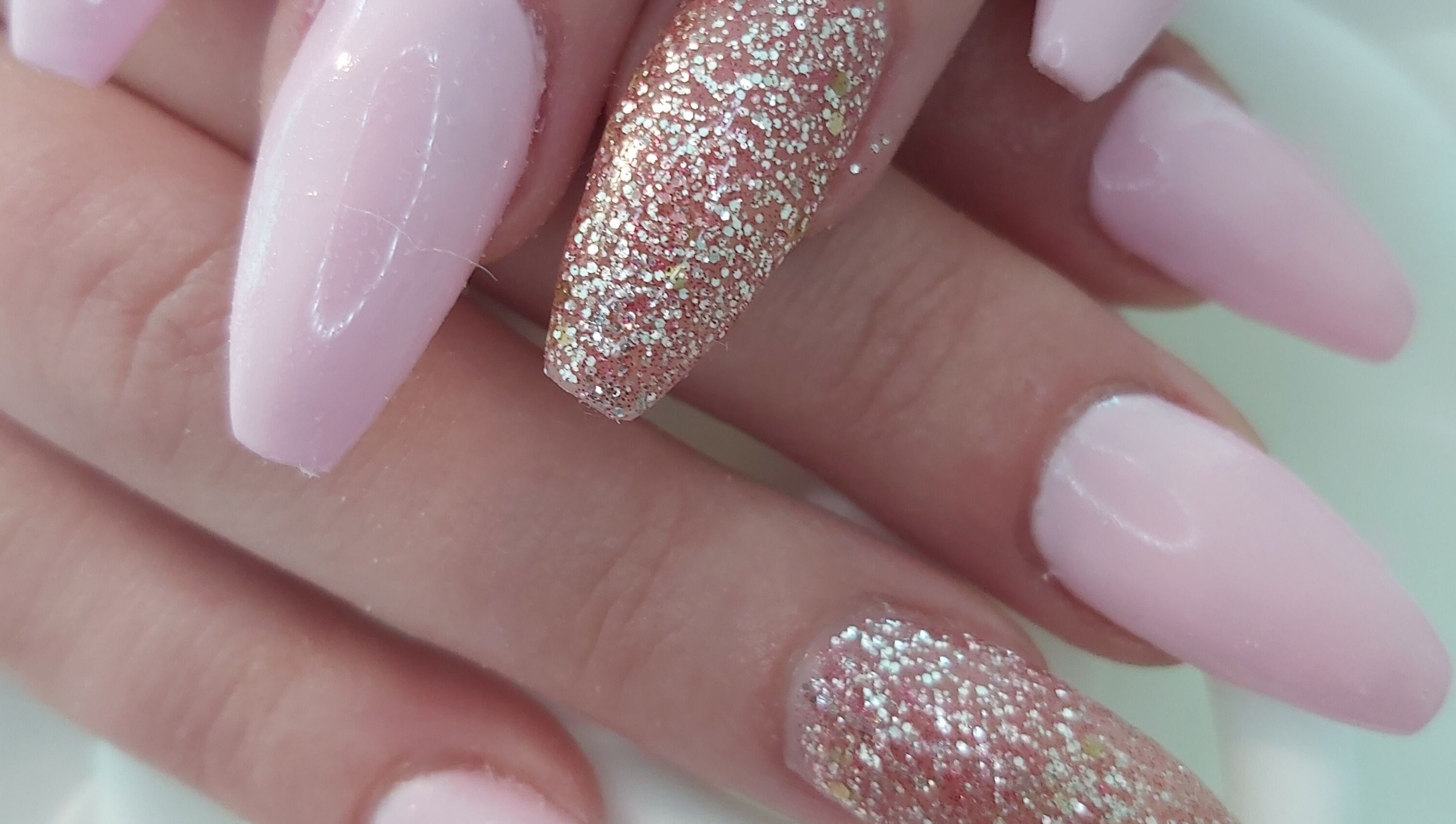 Glitter pink nail art at Tips To Toes Cabin in Holmewood, England, GB, offering vibrant beauty services.