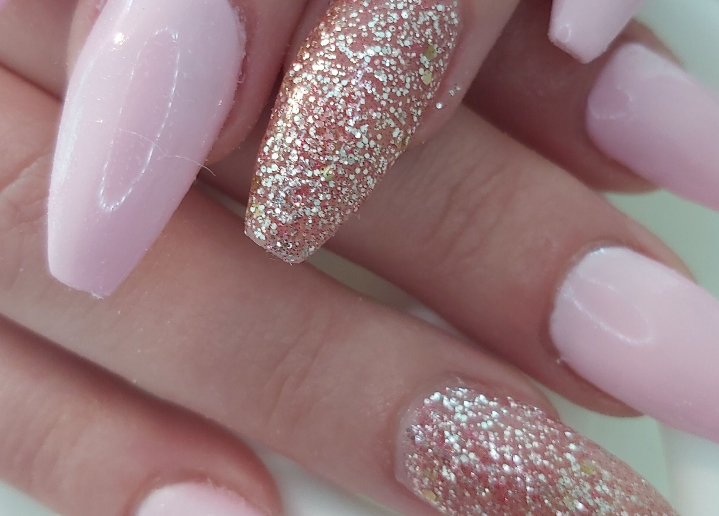 Glitter pink nail art at Tips To Toes Cabin in Holmewood, England, GB, offering vibrant beauty services.