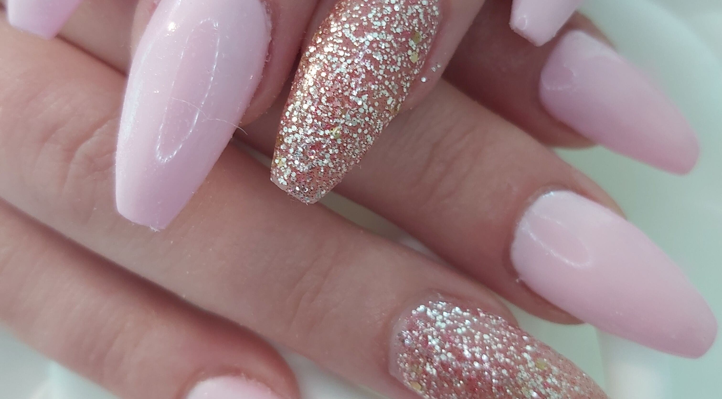 Glitter pink nail art at Tips To Toes Cabin in Holmewood, England, GB, offering vibrant beauty services.