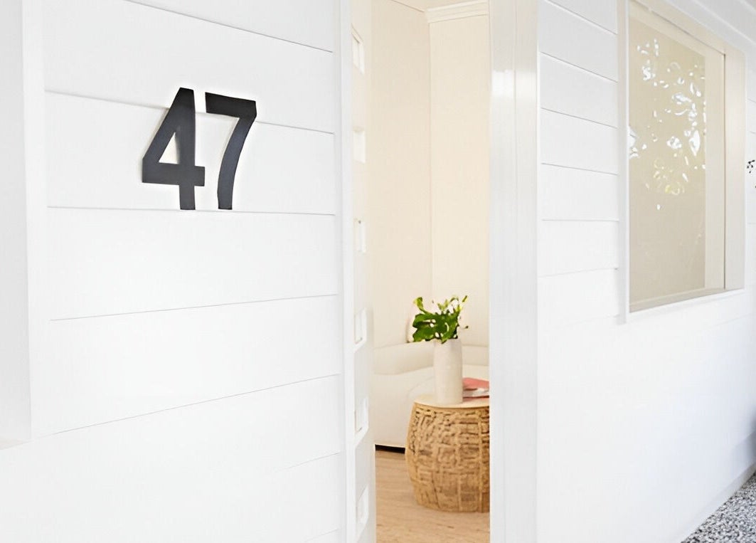 White-walled entrance of The Mane Stylist at Red Hill, Queensland, AU, showcasing elegance and modern design.