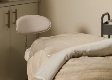 Relaxing spa treatment room at The Mane Stylist in Red Hill, Queensland, AU, featuring a comfortable bed.