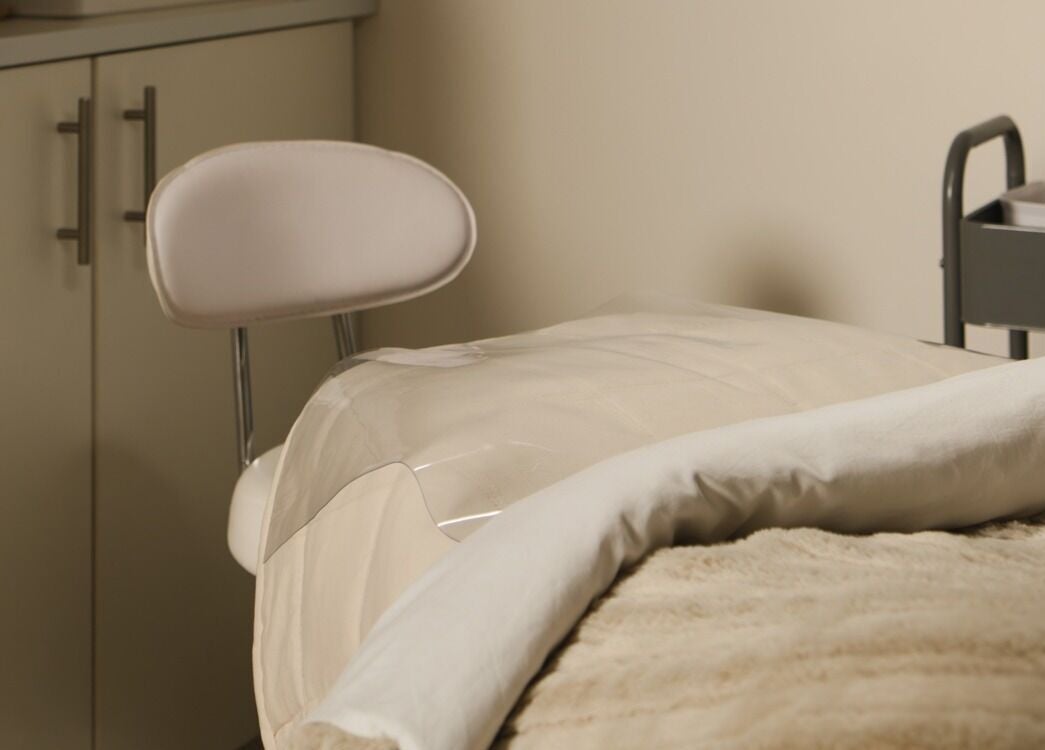 Relaxing spa treatment room at The Mane Stylist in Red Hill, Queensland, AU, featuring a comfortable bed.