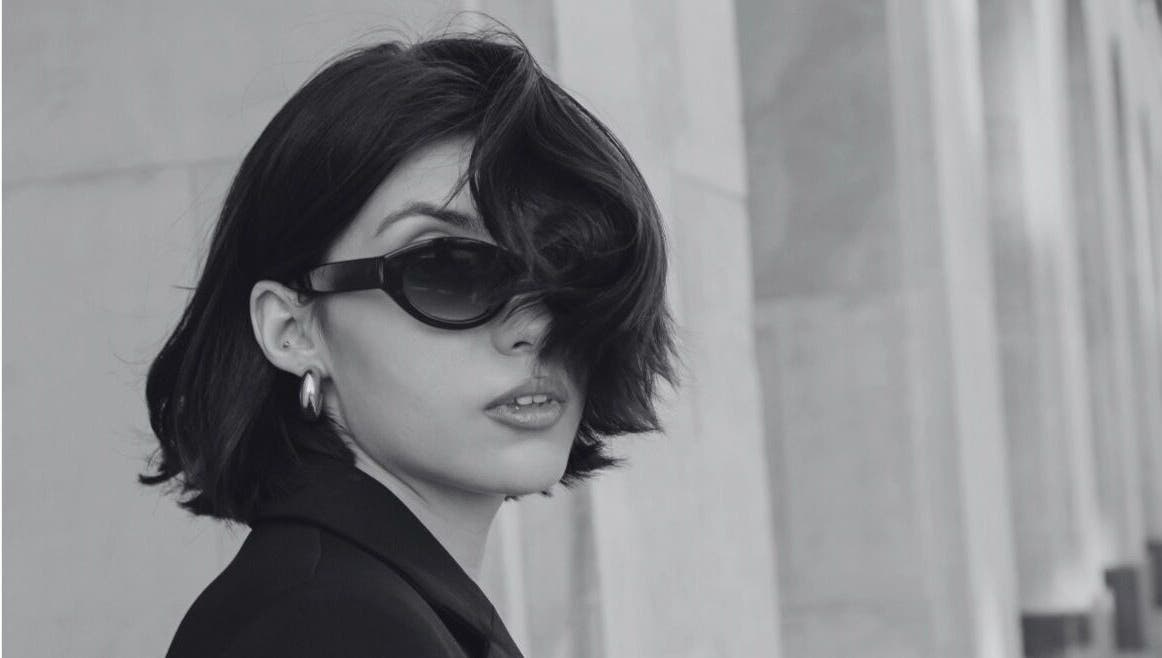 Stylish woman in black sunglasses at David James San Francisco, San Francisco, California, US.