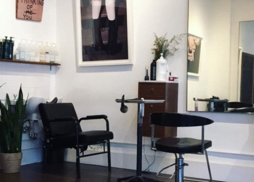 Stylish salon seating at David James | Marin, San Rafael, California, US with modern decor and a large mirror.