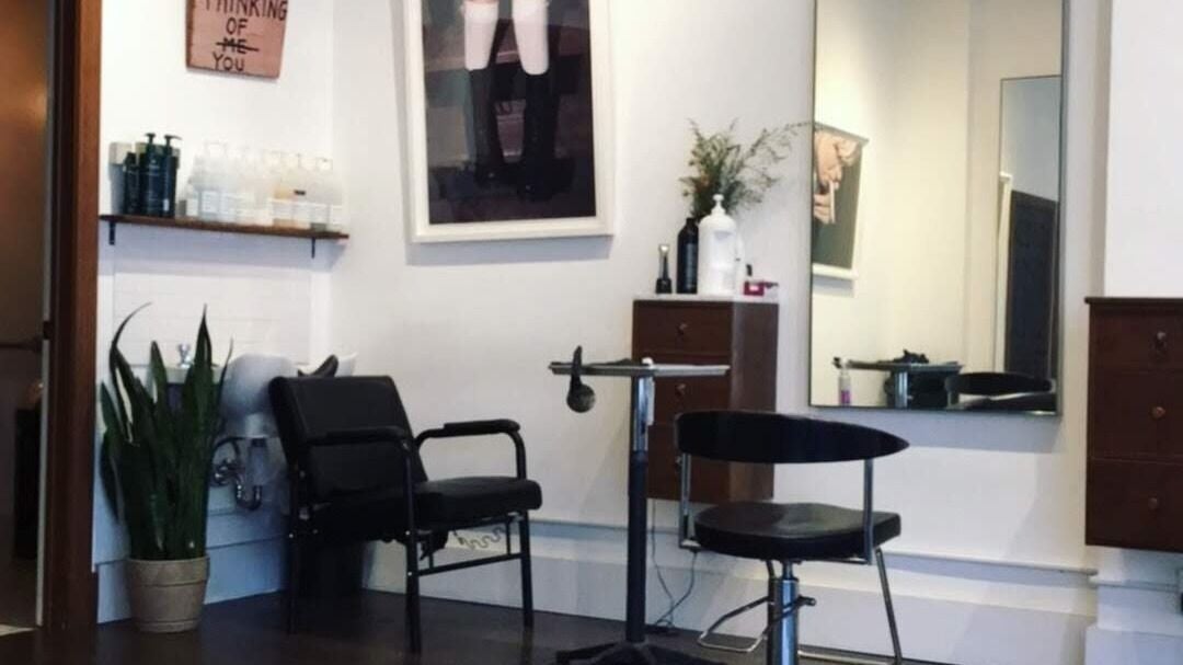 Stylish salon seating at David James | Marin, San Rafael, California, US with modern decor and a large mirror.