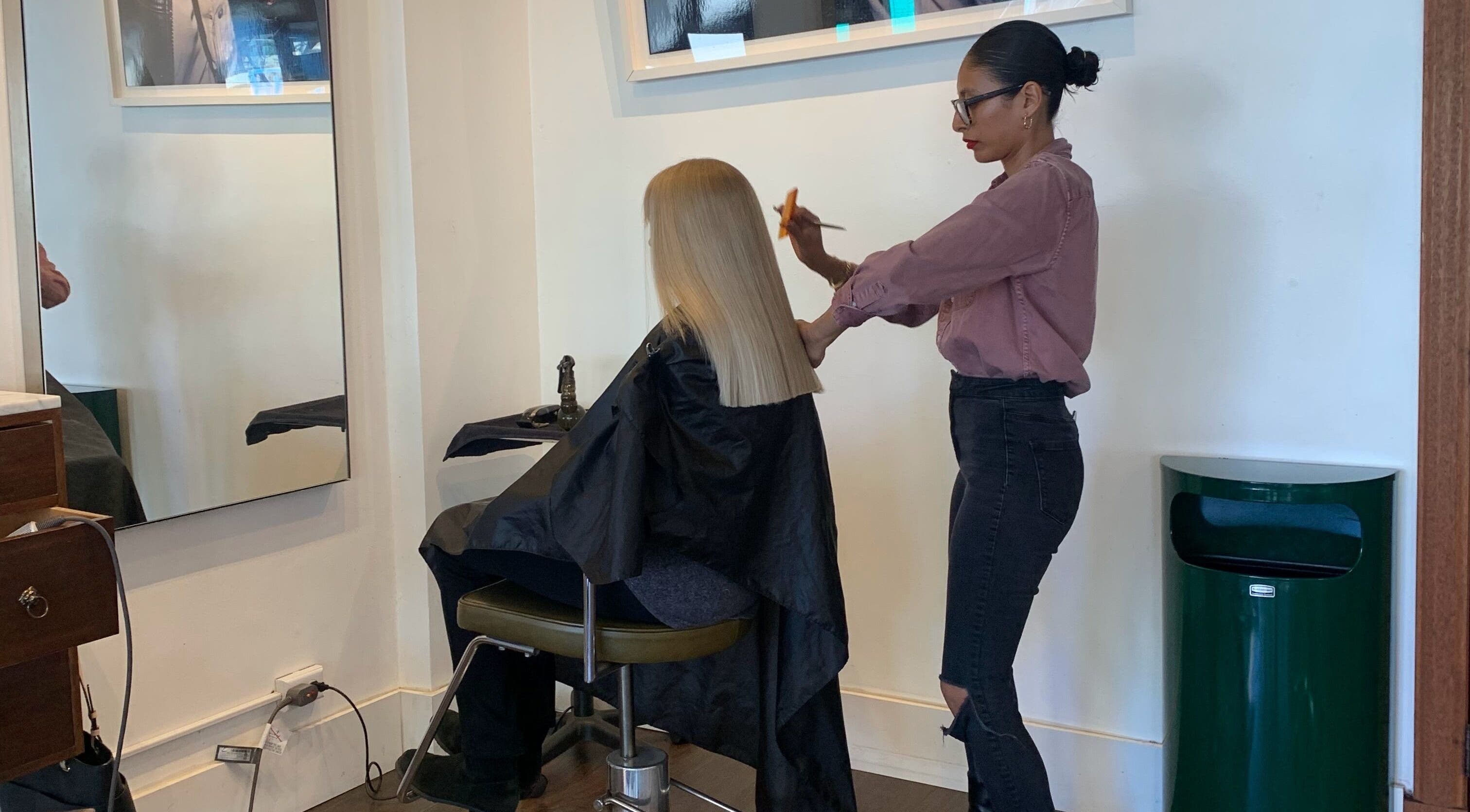 Expert haircut at David James | Marin in San Rafael, California, US. Hairstylist perfects a sleek, blonde look.