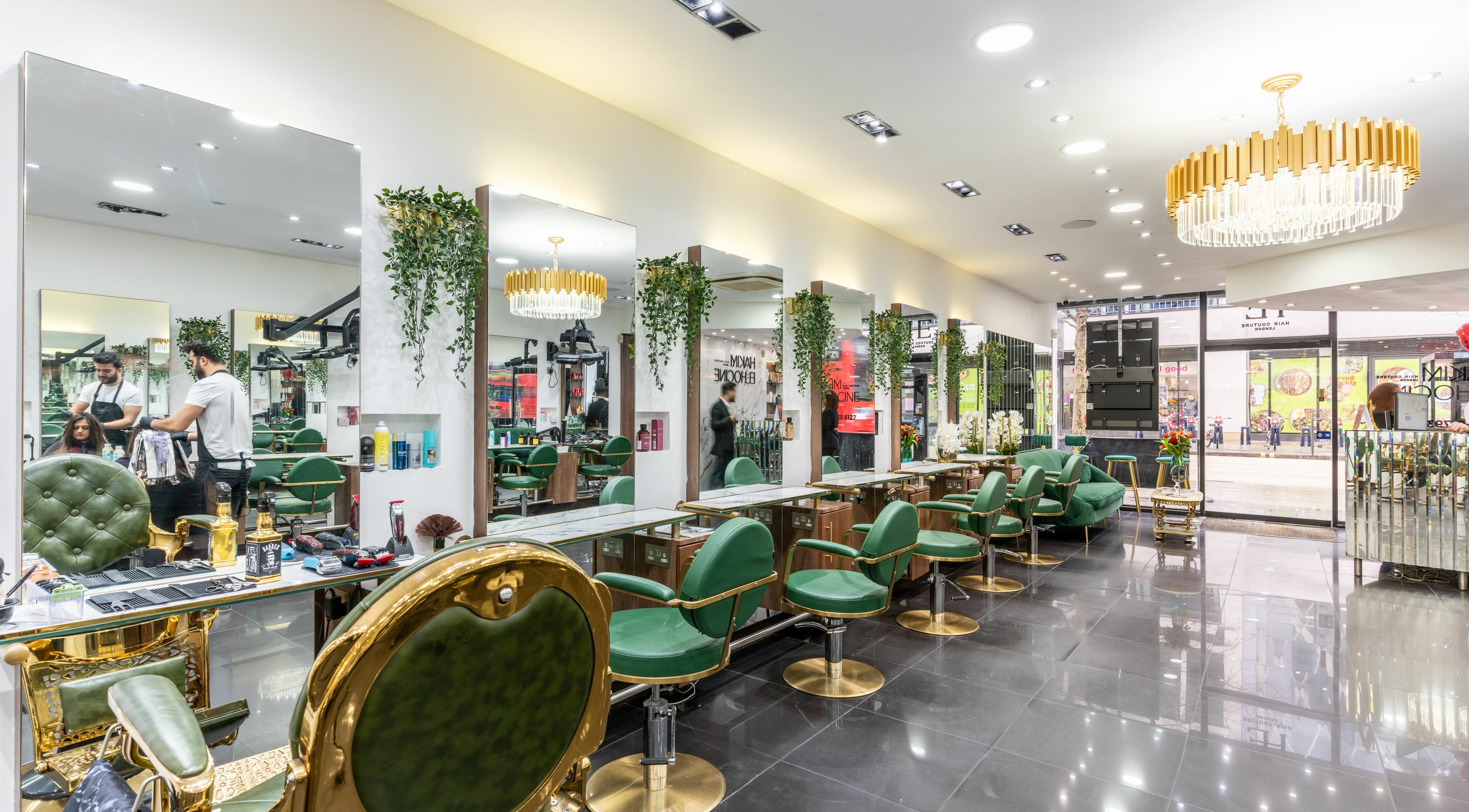 Luxurious interior of Hakim Elhocine Hair salon in London, England, GB featuring elegant green chairs.