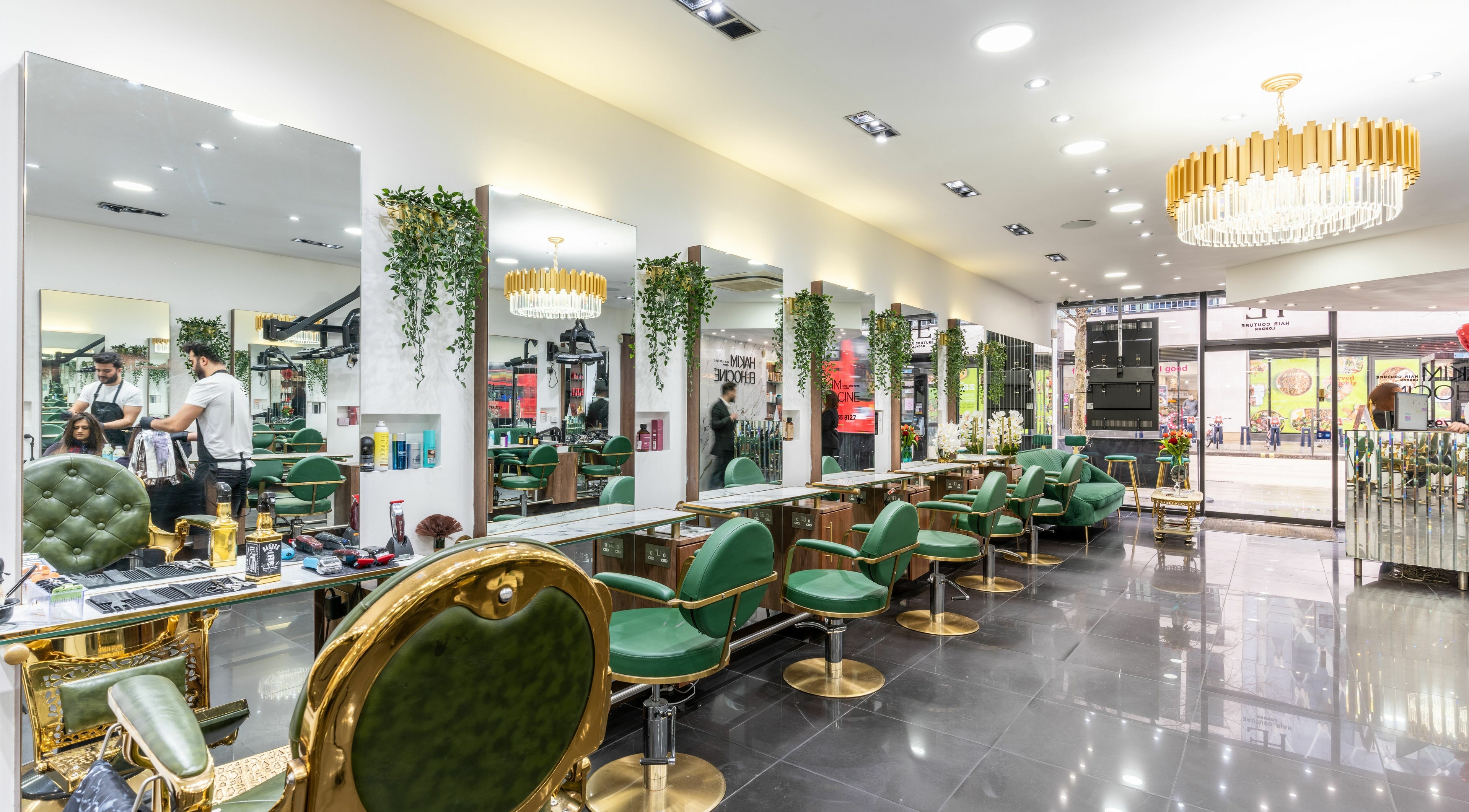 Luxurious interior of Hakim Elhocine Hair salon in London, England, GB featuring elegant green chairs.