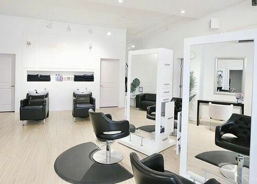 Modern salon chairs and mirrors at Posh & Pixie, Kenora, Ontario, CA inviting a luxurious experience.