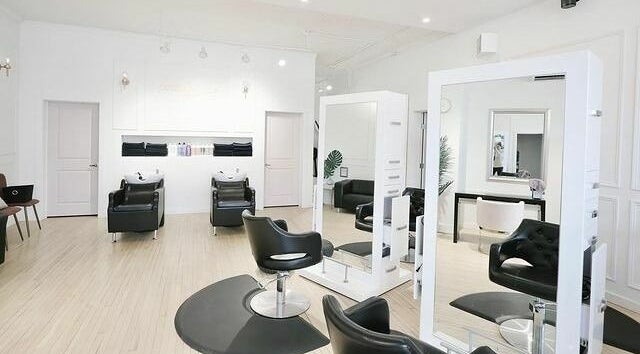 Modern salon chairs and mirrors at Posh & Pixie, Kenora, Ontario, CA inviting a luxurious experience.