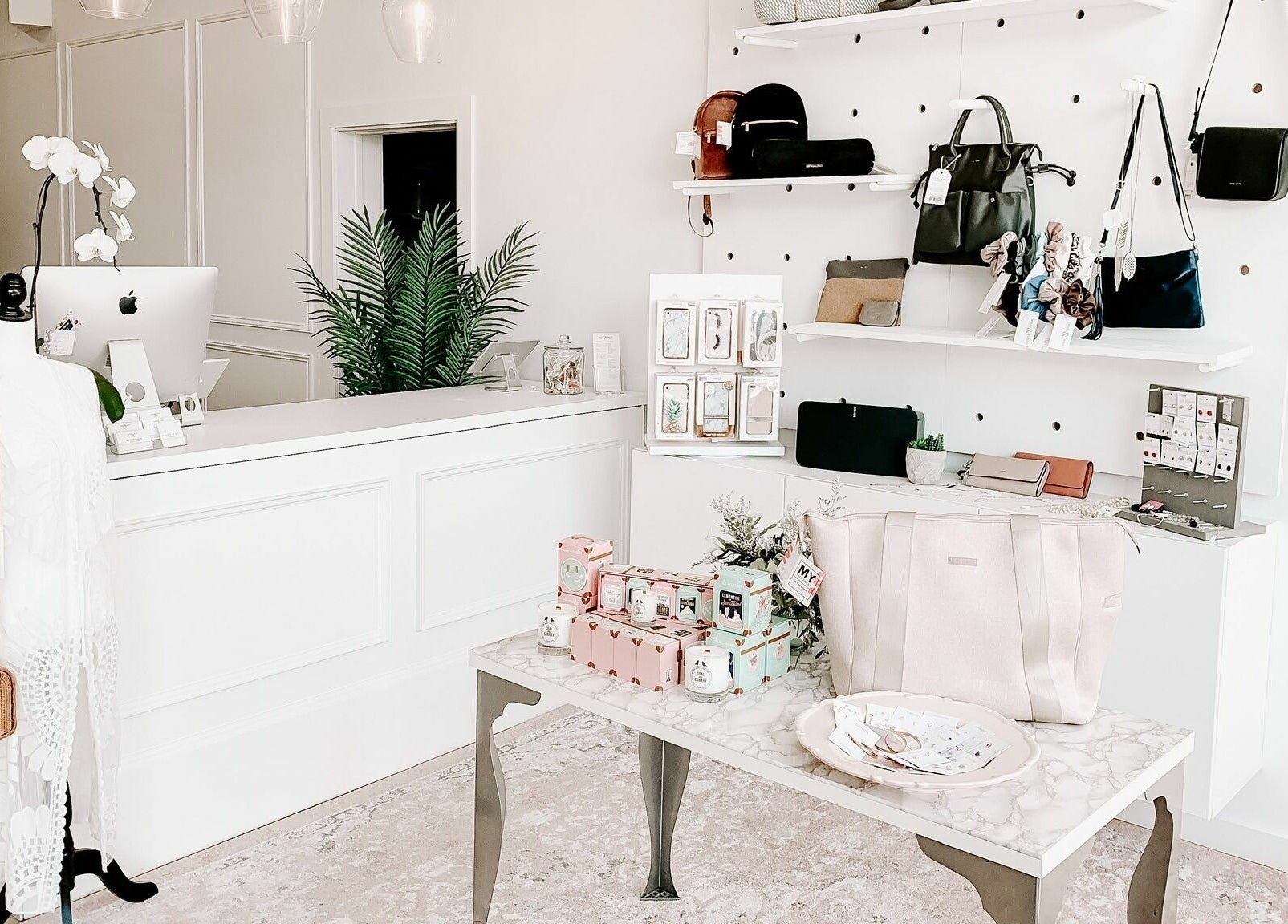 Chic interior of Posh & Pixie in Kenora, Ontario, CA, showcasing stylish bags and beauty products.