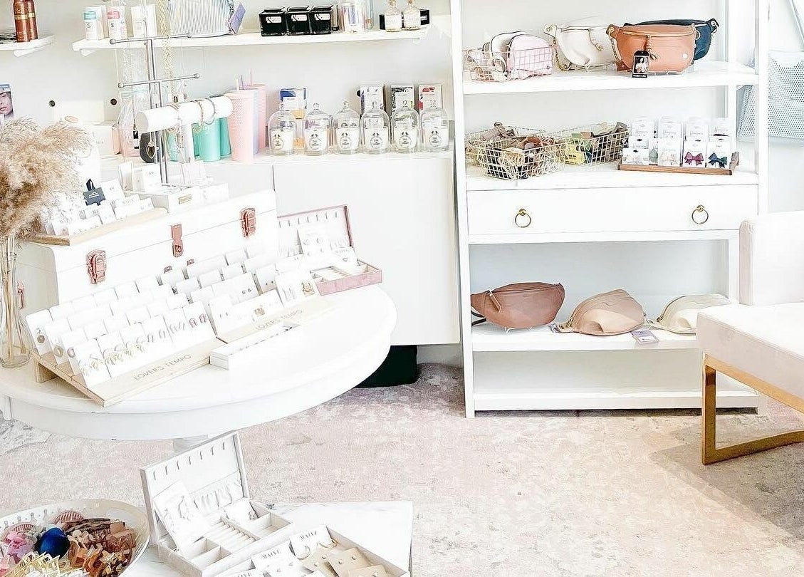 Elegant display of beauty products at Posh & Pixie, Kenora, Ontario, CA, featuring jewelry and skincare items.