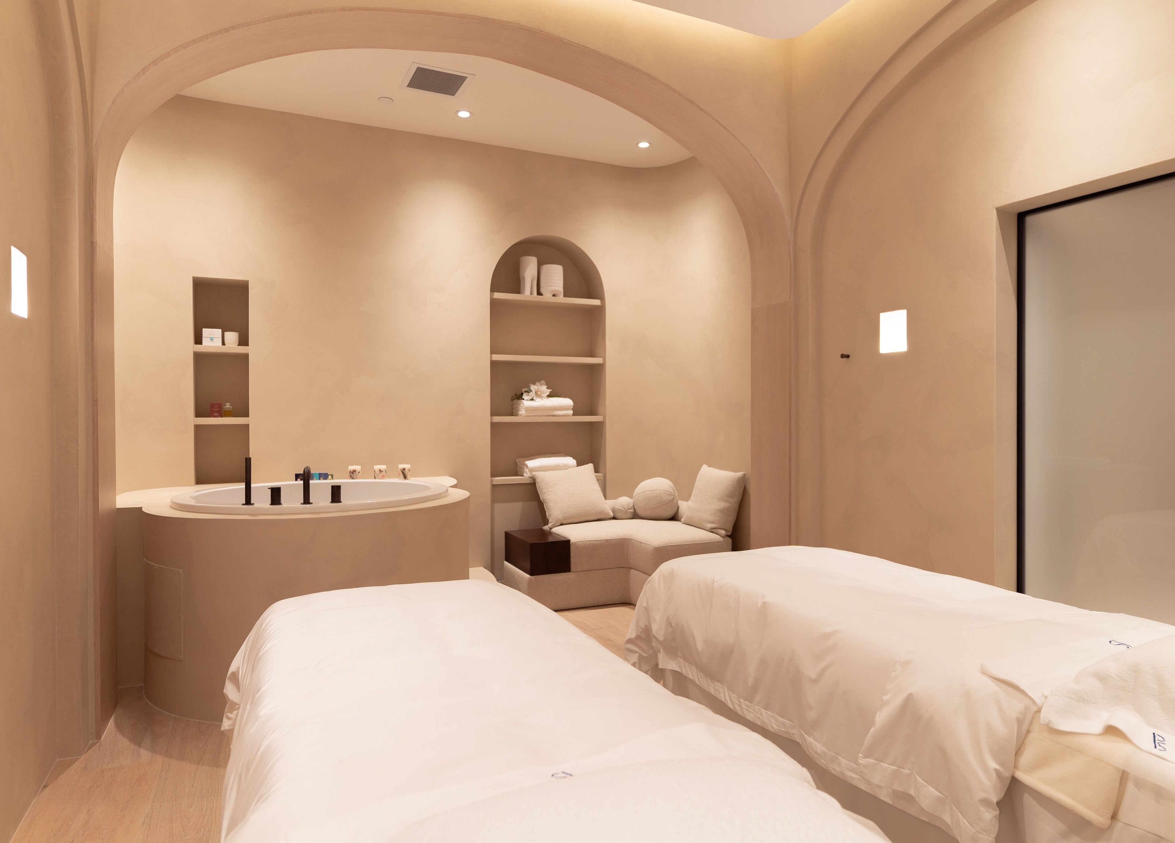 Luxurious treatment room at Pemberley Springs SPA EDEN, Toronto, Ontario, CA, featuring cozy beds and a tranquil ambiance.