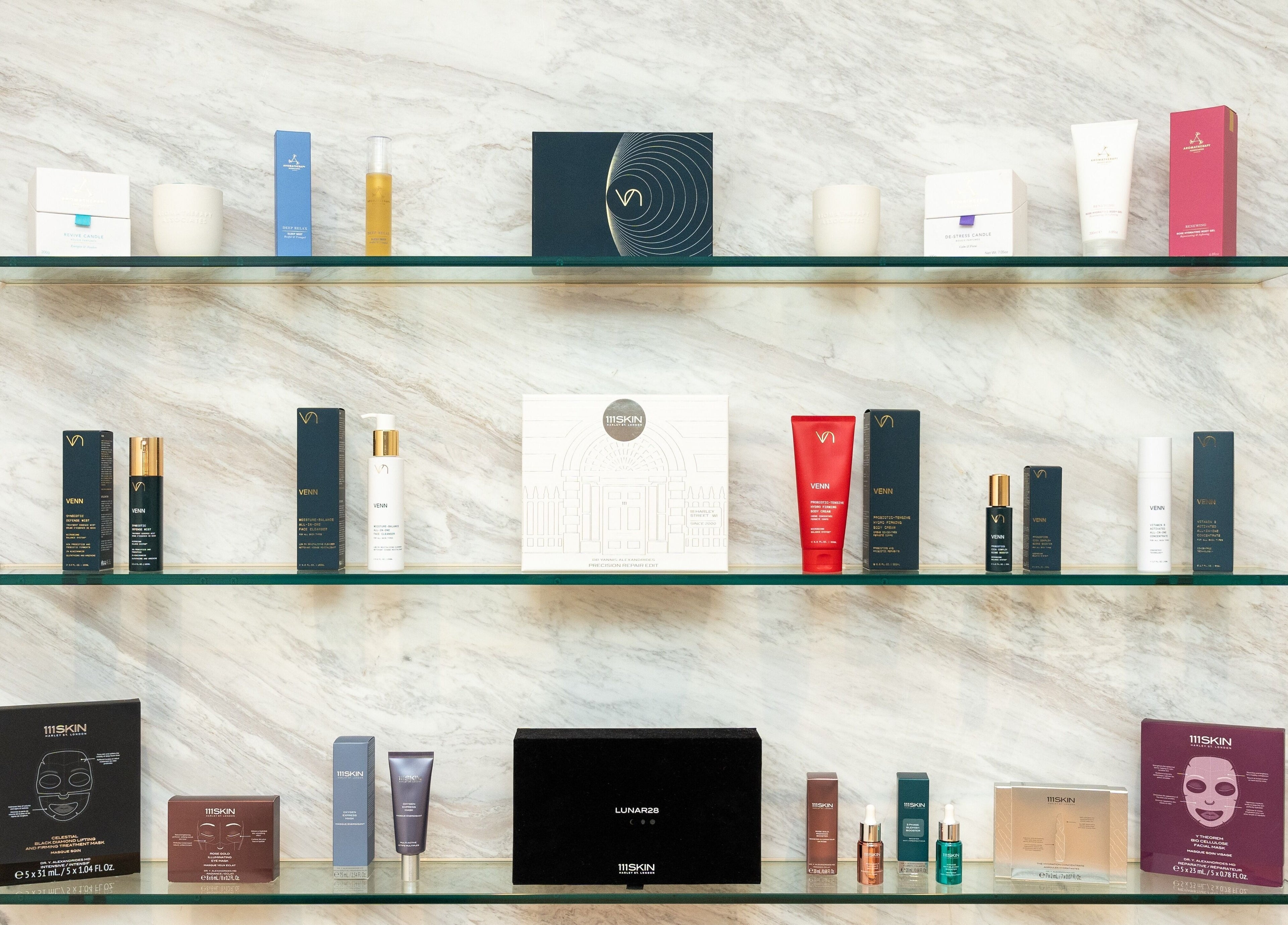 A collection of luxury beauty products on glass shelves at Pemberley Springs SPA EDEN, Toronto, Ontario, CA.