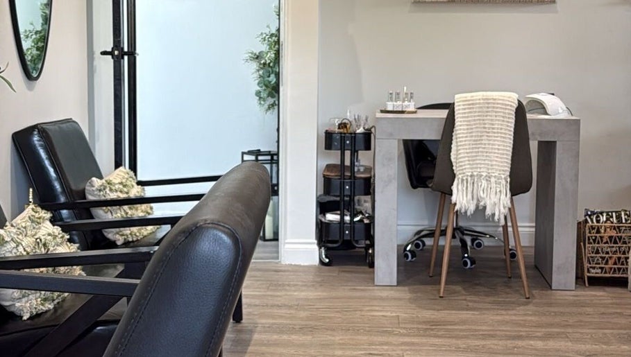 Modern seating area at Aaliyahbrookesbeauty in Telford, England, GB, featuring plush chairs and a stylish table.