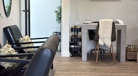 Modern seating area at Aaliyahbrookesbeauty in Telford, England, GB, featuring plush chairs and a stylish table.