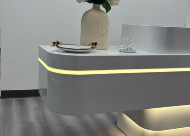 Reception desk with modern lighting at Urban Brows West, Edmonton, Alberta, CA.