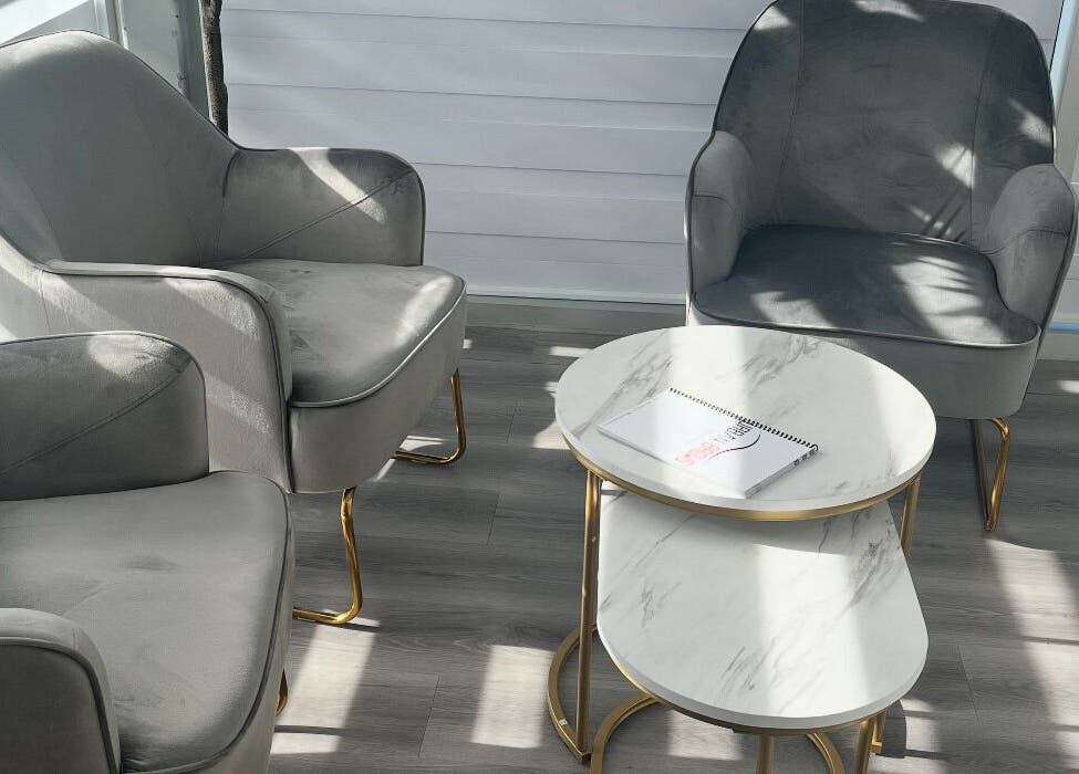 Modern gray chairs and tables at Urban Brows West, Edmonton, Alberta, CA, perfect for relaxation.