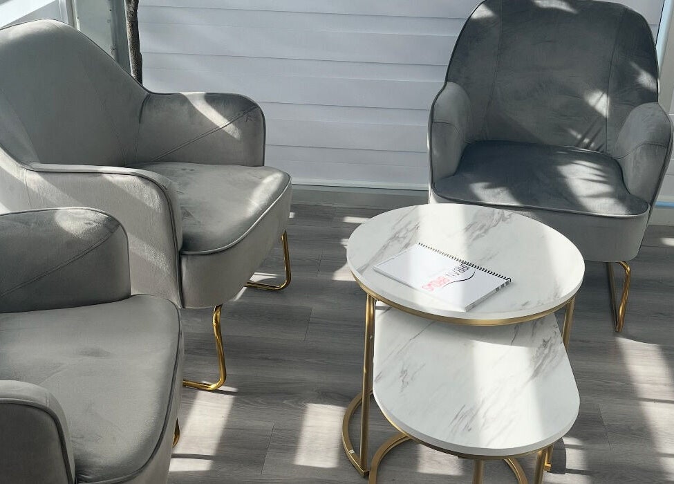 Modern gray chairs and tables at Urban Brows West, Edmonton, Alberta, CA, perfect for relaxation.