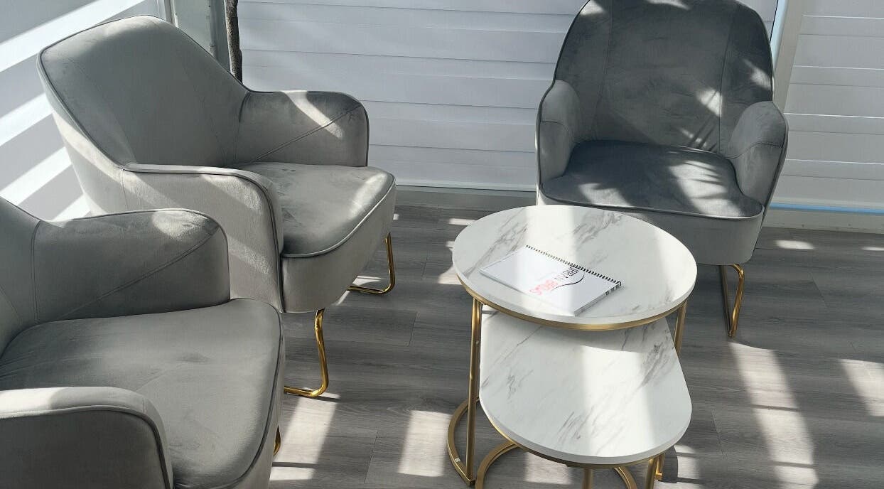 Modern gray chairs and tables at Urban Brows West, Edmonton, Alberta, CA, perfect for relaxation.
