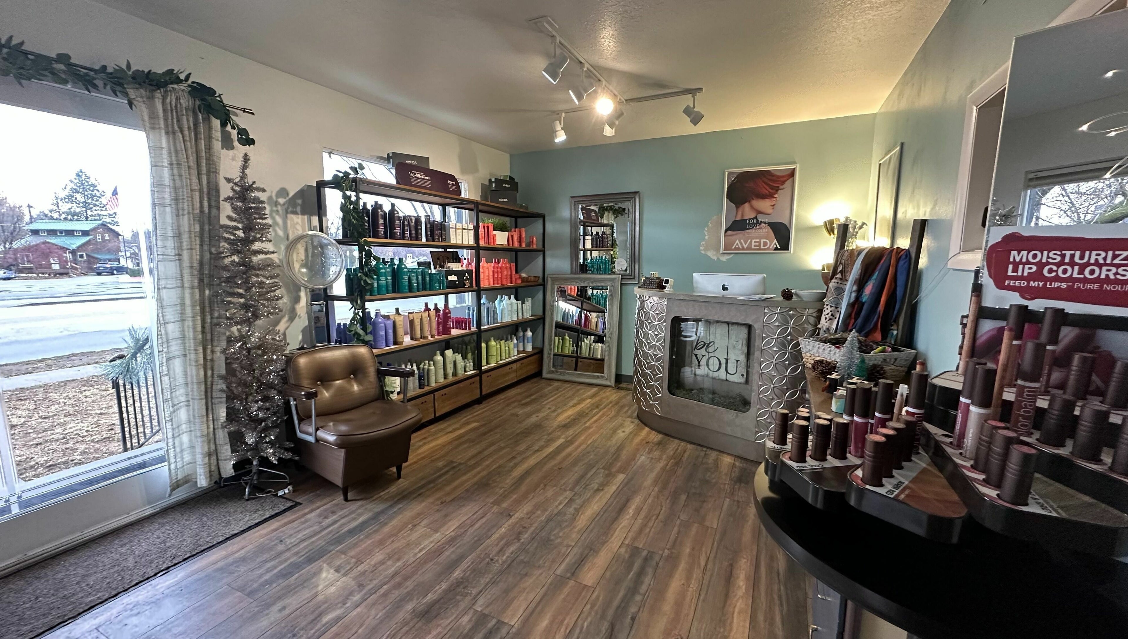 Interior of Bombshells and Blokes Salon, Boise, Idaho, US featuring shelves of beauty products and comfortable seating.
