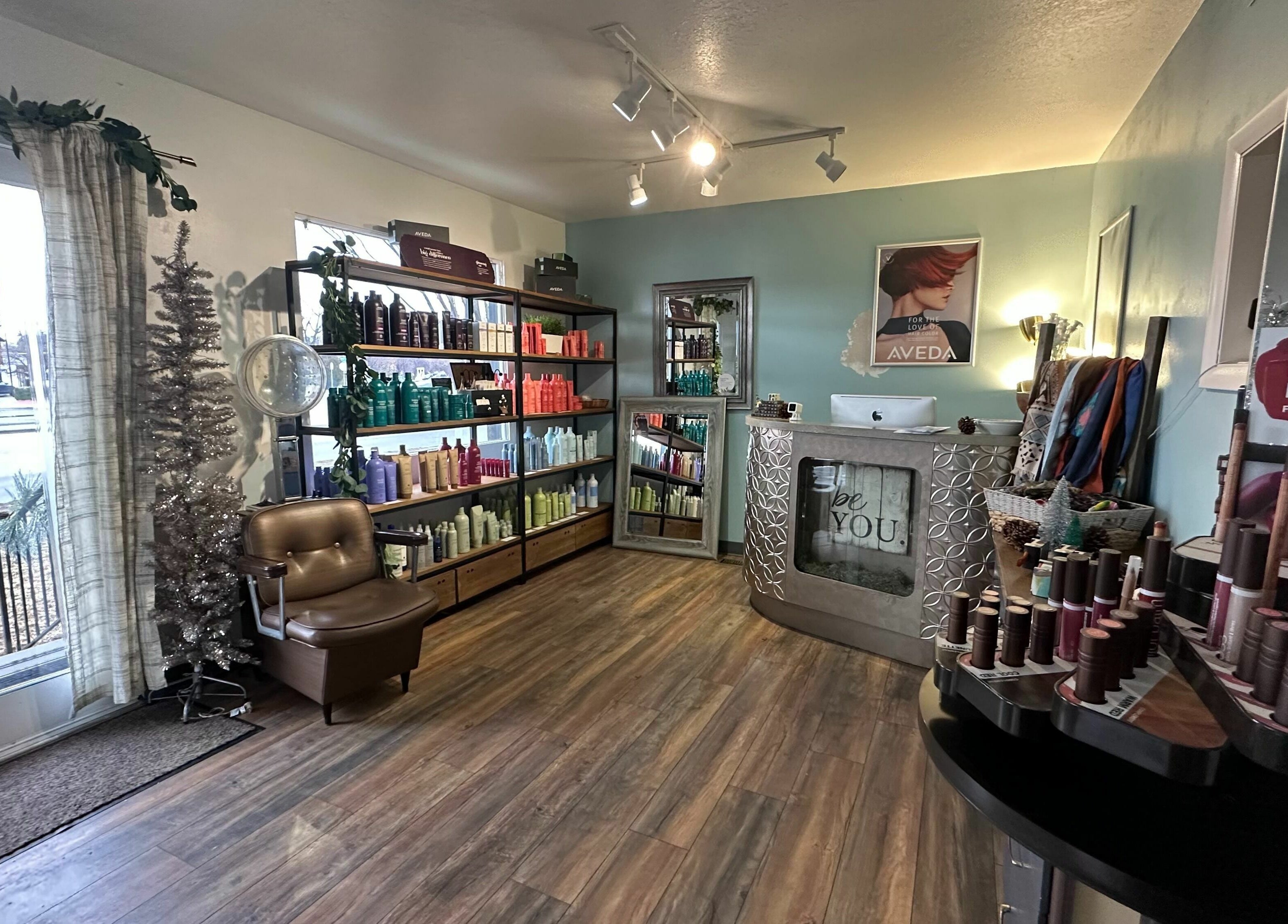 Interior of Bombshells and Blokes Salon, Boise, Idaho, US featuring shelves of beauty products and comfortable seating.