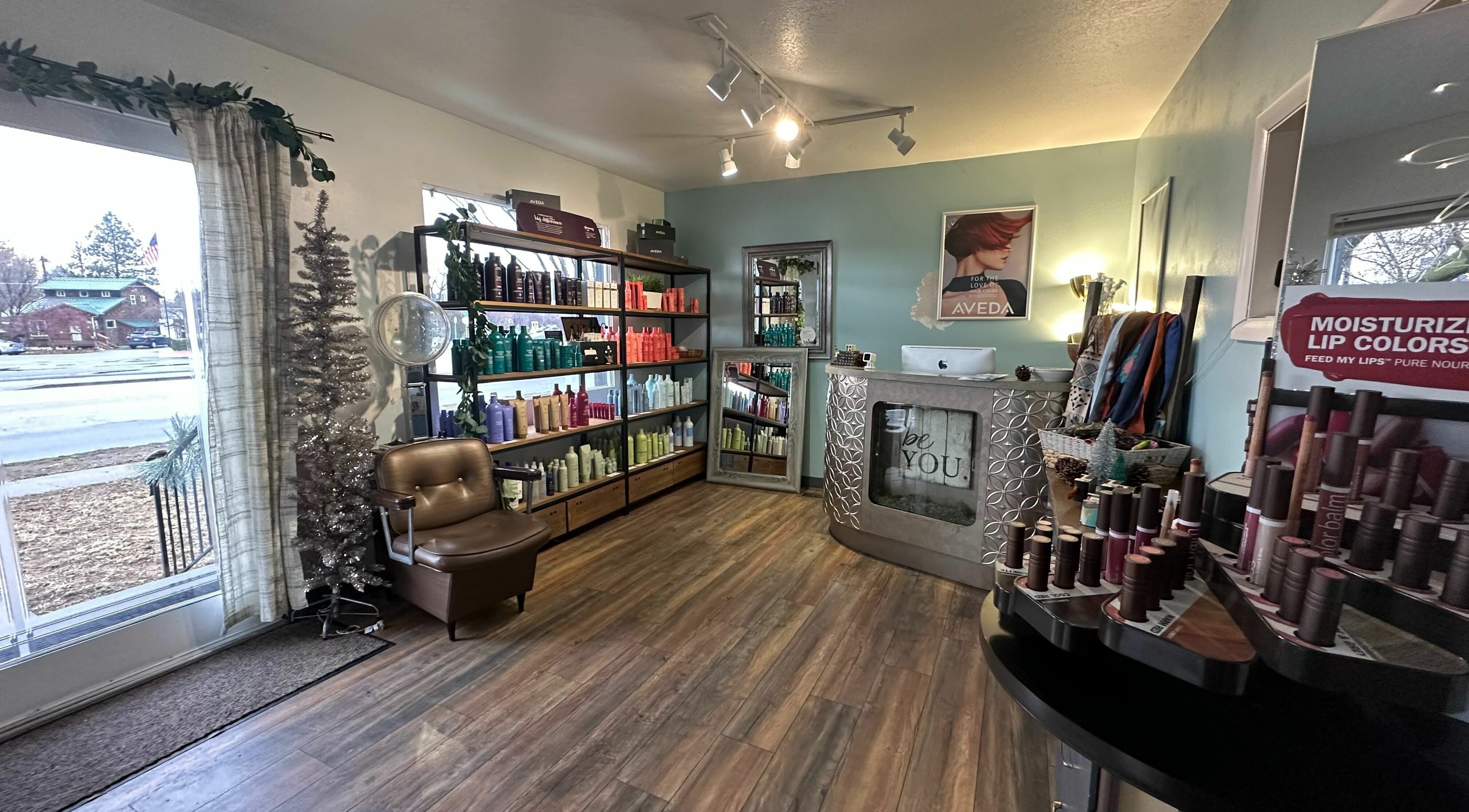 Interior of Bombshells and Blokes Salon, Boise, Idaho, US featuring shelves of beauty products and comfortable seating.