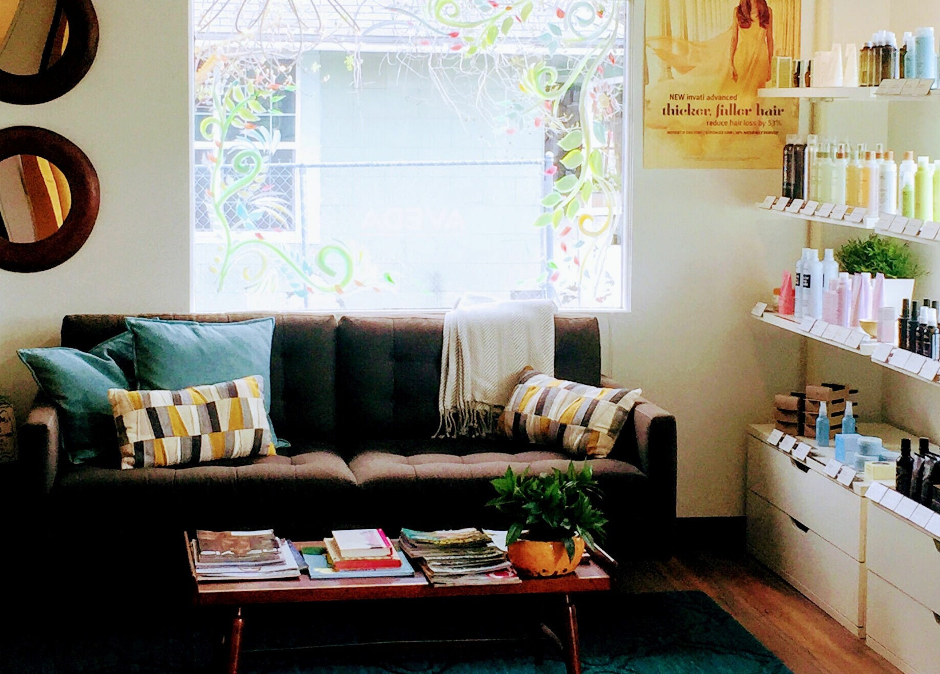 Cozy waiting area at Bombshells and Blokes Salon in Boise, Idaho, US with a couch and product shelves.