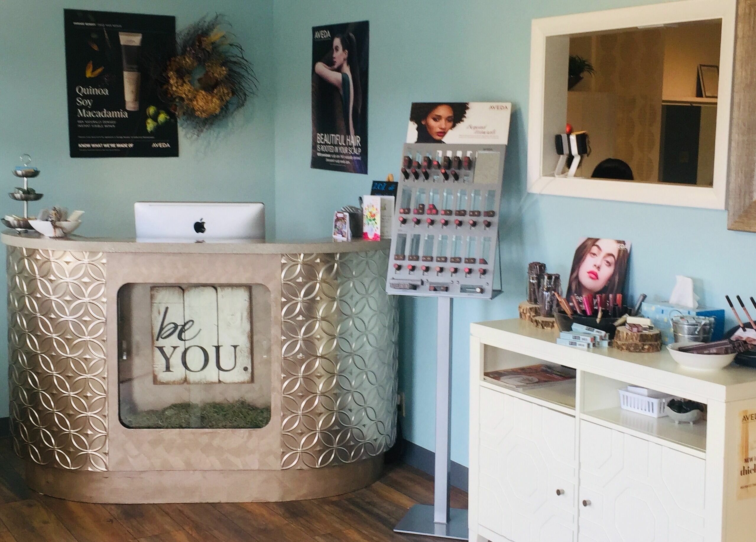 Reception area at Bombshells and Blokes Salon in Boise, Idaho, US, showcasing a stylish front desk.
