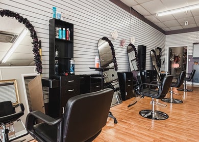 Interior of Premier Beauty in Berea, Kentucky, US with stylish salon chairs and mirrors.