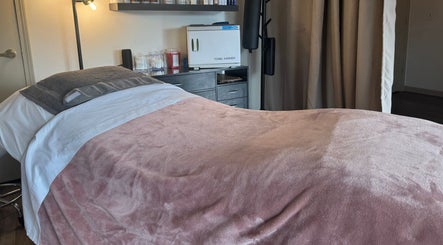 Cozy treatment room at Skinfluential LLC, West Linn, Oregon, US, with plush pink blanket and modern decor.