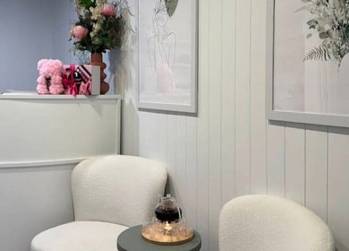 Elegant waiting area at Zen & Chill - Massage, Paradise Point, Queensland, AU with chairs and floral decor.