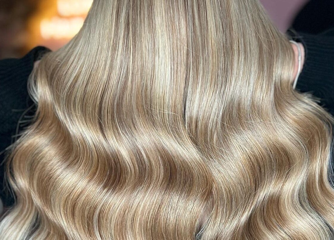 Blonde wavy hair styled at Loxy Locks Hair Extensions, Belper, England, GB, showcasing glossy texture.