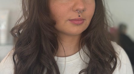 A close-up of styled brown curls and piercings at Kerry Miller Hair, Cove Bay, Scotland, GB.