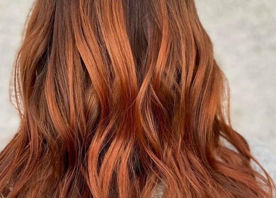 Vibrant copper hair waves at Kerry Miller Hair, Cove Bay, Scotland, GB