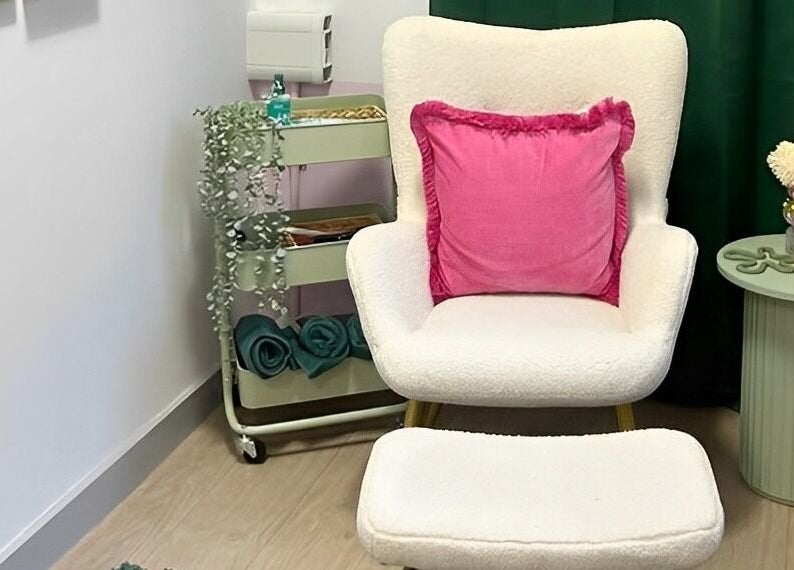 Cozy relaxation chair with pink cushion at The Beauty Bar Bristol, Stoke Gifford, England, GB.