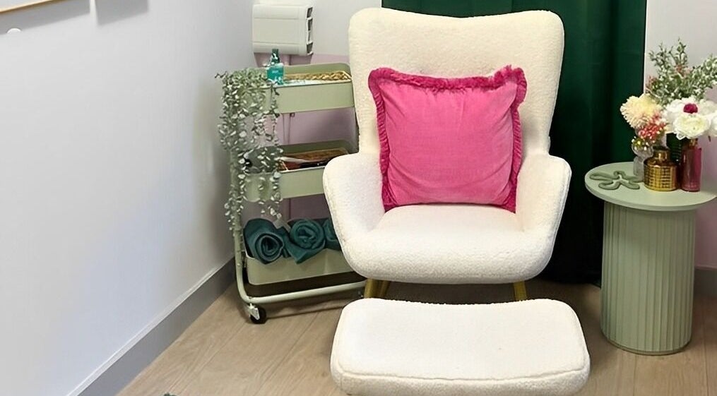 Cozy relaxation chair with pink cushion at The Beauty Bar Bristol, Stoke Gifford, England, GB.