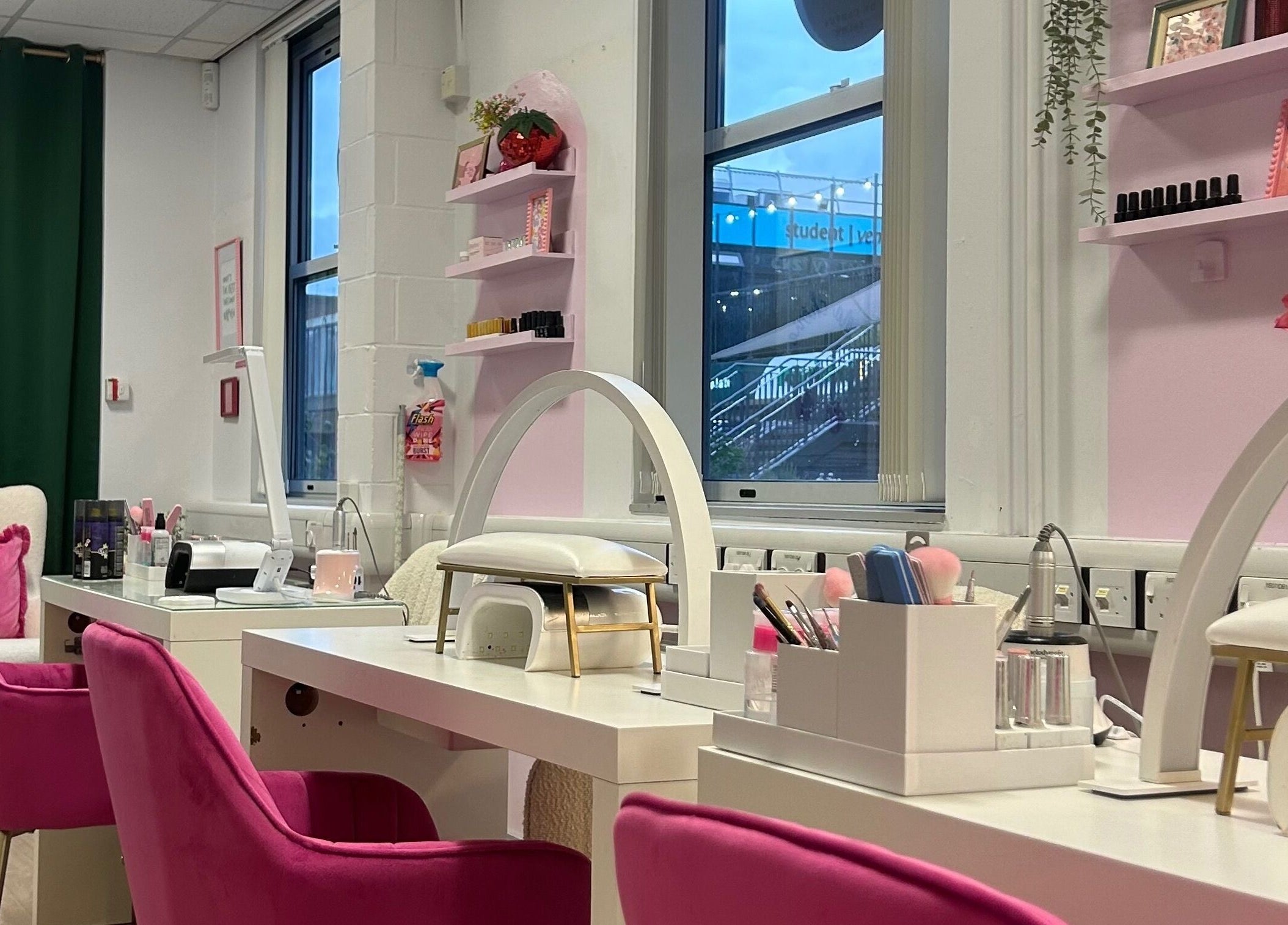 Stylish interior at The Beauty Bar Bristol, Stoke Gifford, England, GB with pink chairs and beauty stations.