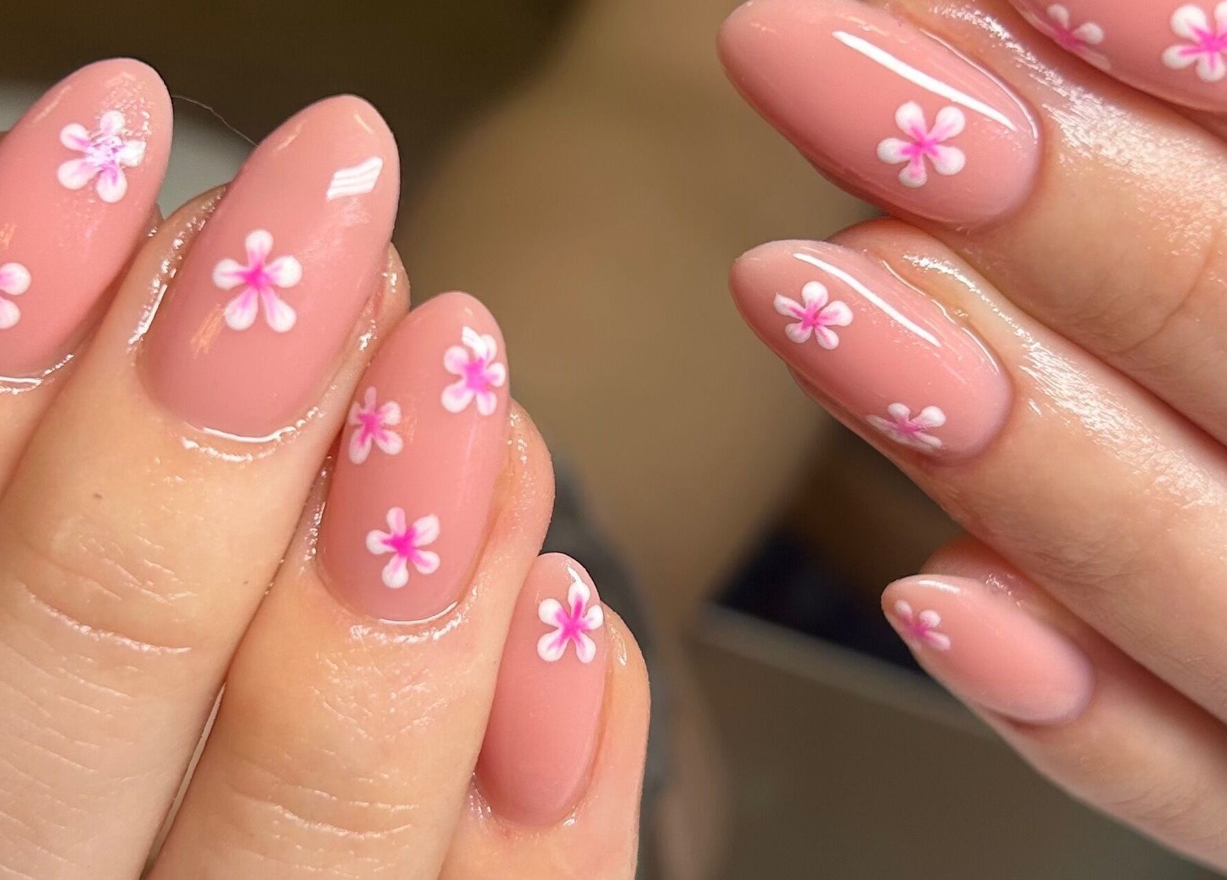 Floral nail art at The Beauty Bar Bristol, Stoke Gifford, England, GB. Pink flowers on manicured nails.