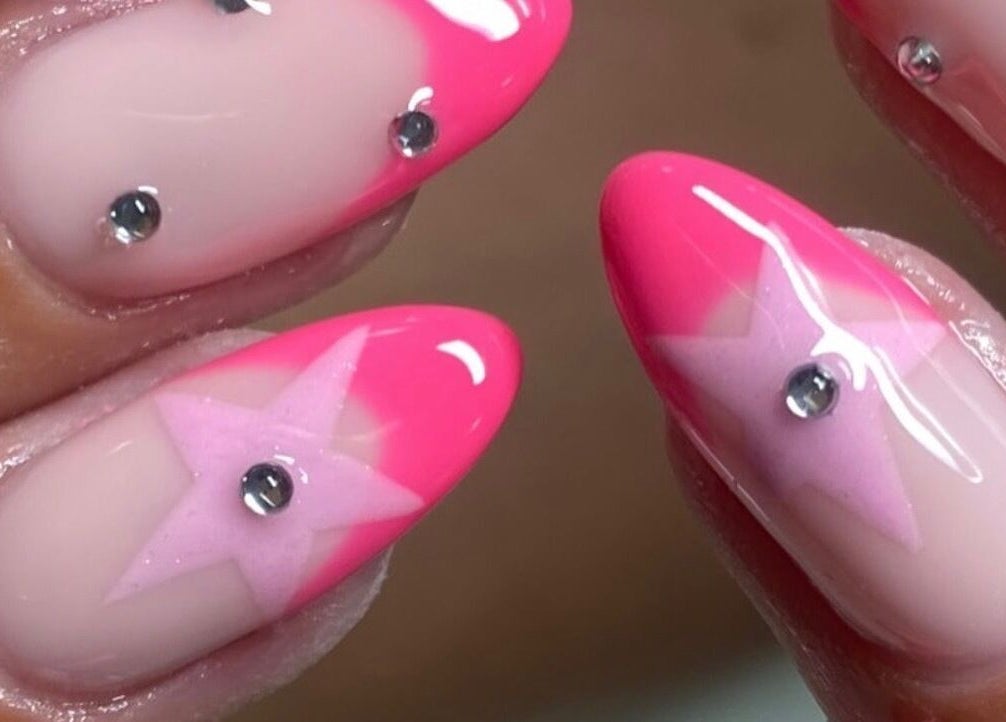 Pink star nail art with rhinestones at The Beauty Bar Bristol in Stoke Gifford, England, GB.