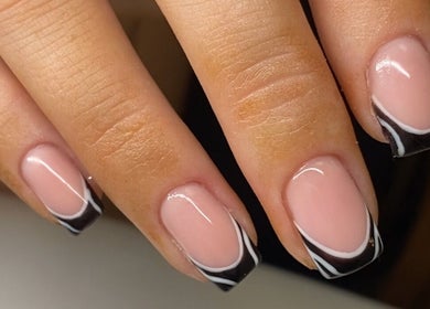 Elegant nail art at Bare Beauty, Bournemouth, England, GB showcasing sleek black and white designs.