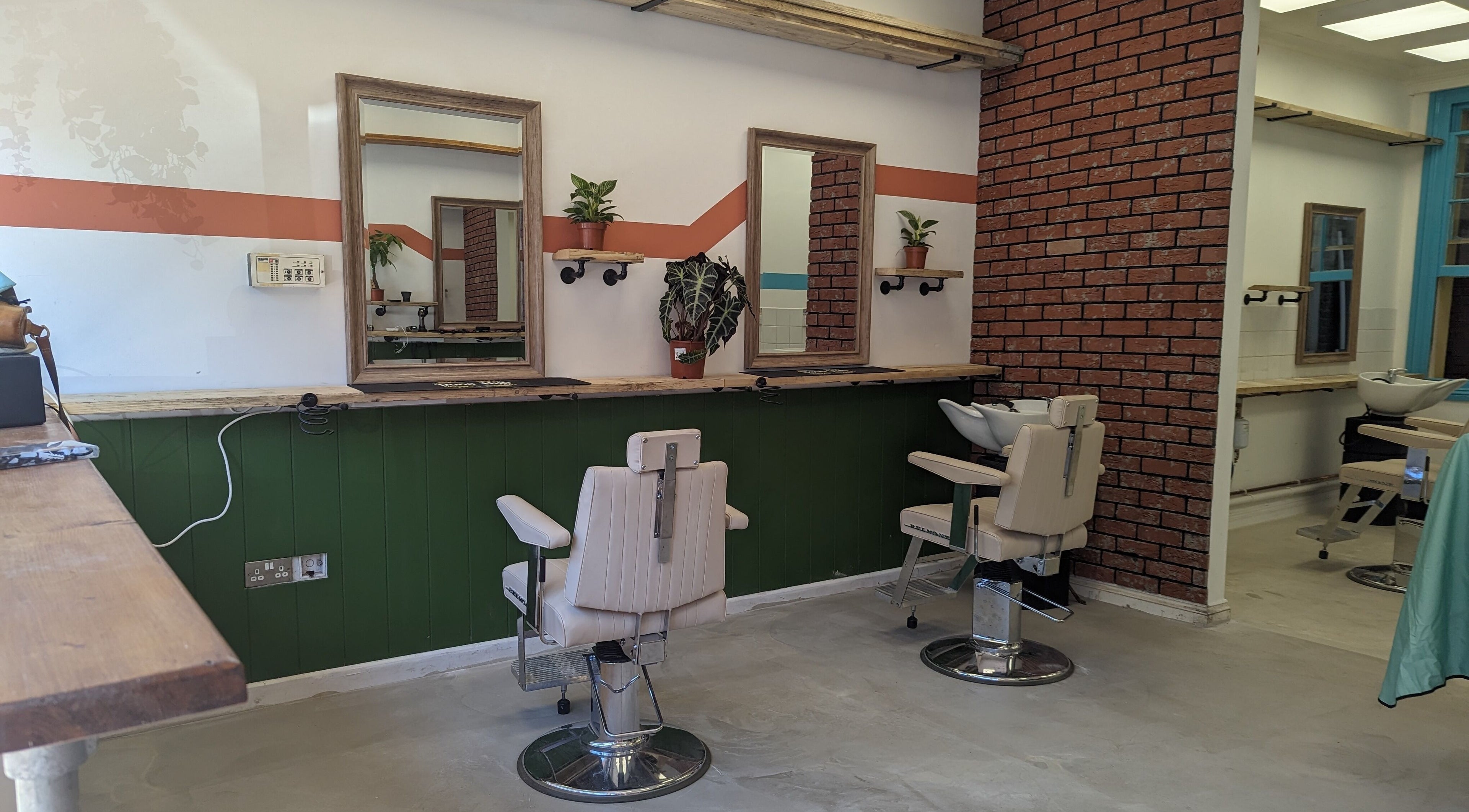 Modern salon interior at dooo Hub - Old Market (Gender Free), Bristol, England, GB with chic styling chairs.